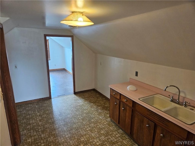 interior space featuring vanity and vaulted ceiling