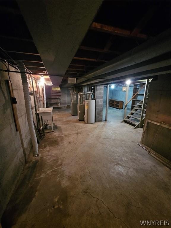 basement featuring gas water heater and heating unit