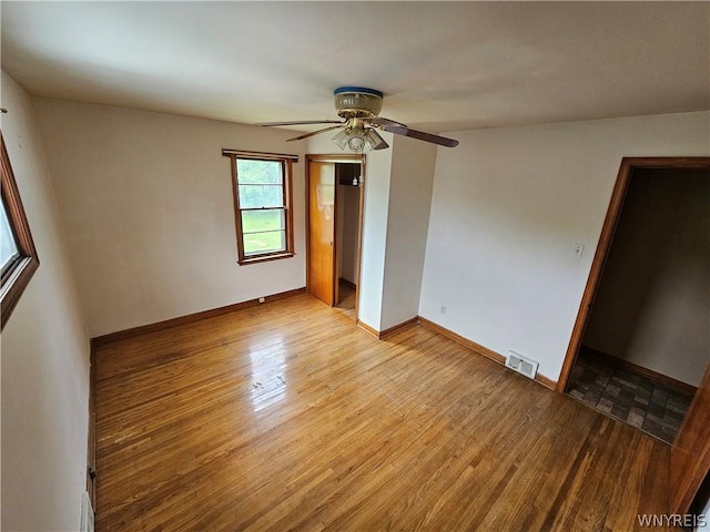 spare room featuring ceiling fan and light hardwood / wood-style floors