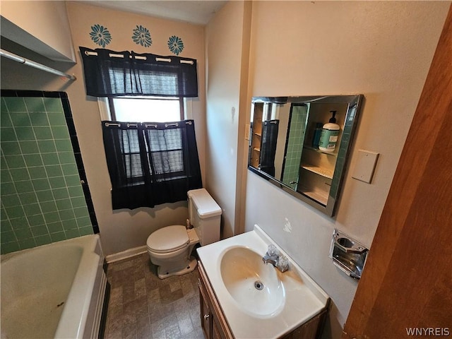 full bathroom with tiled shower / bath, vanity, and toilet