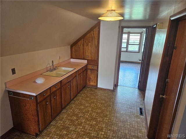 interior space featuring sink and lofted ceiling