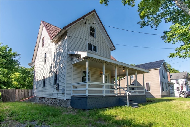 back of property with a lawn