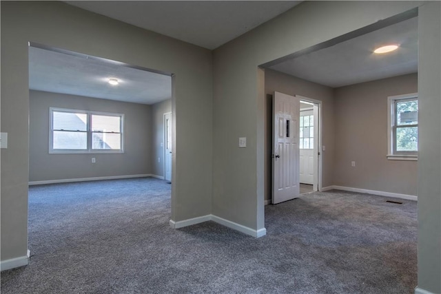 empty room featuring dark colored carpet