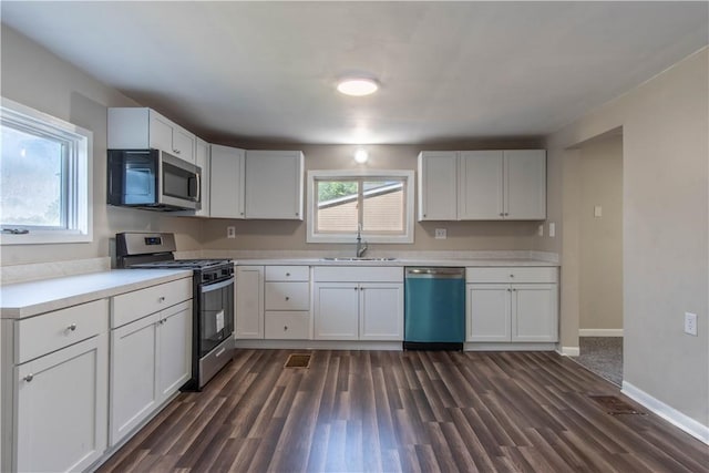 kitchen featuring sink, white cabinetry, and appliances with stainless steel finishes