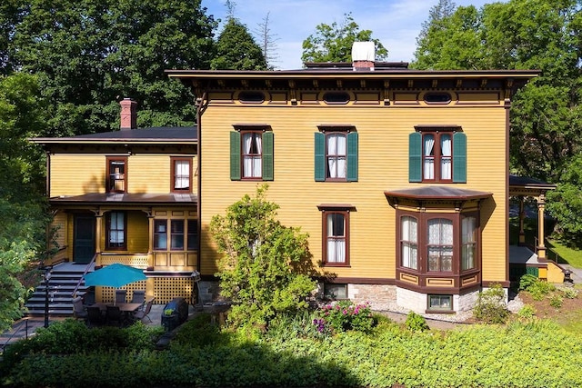 73 Elm St, Otsego, NY 13326 - rear view of house with a chimney