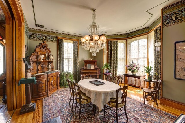 dining space with a notable chandelier and hardwood / wood-style floors