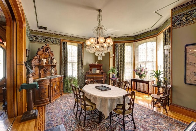 73 Elm St, Otsego, NY 13326 - dining space featuring an inviting chandelier, ornamental molding, and wood finished floors