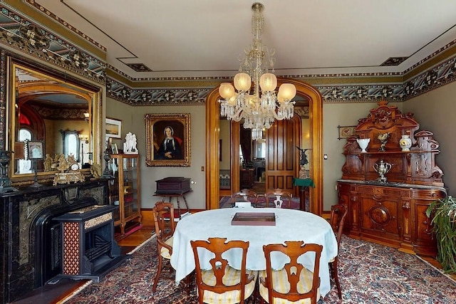 73 Elm St, Otsego, NY 13326 - dining space with an inviting chandelier and a wood stove