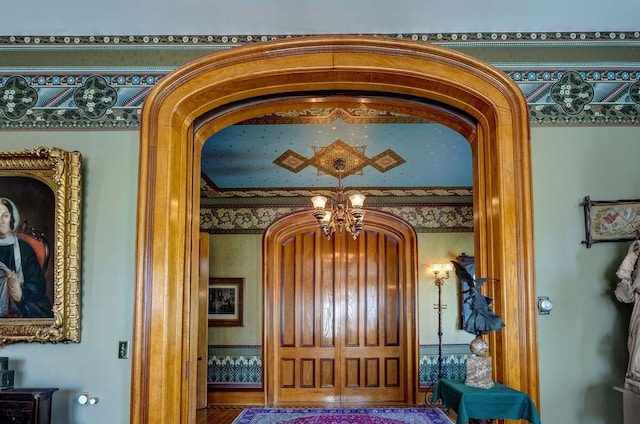 interior details featuring a notable chandelier and hardwood / wood-style floors