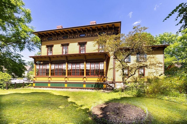 73 Elm St, Otsego, NY 13326 - rear view of property featuring a chimney, a sunroom, and a yard