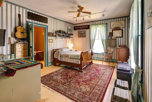 73 Elm St, Otsego, NY 13326 - bedroom featuring wallpapered walls, baseboard heating, and track lighting
