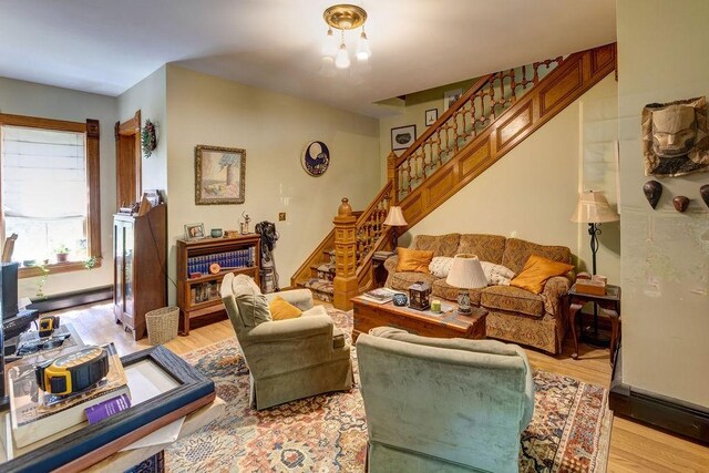 73 Elm St, Otsego, NY 13326 - living area with light wood-style flooring and stairway