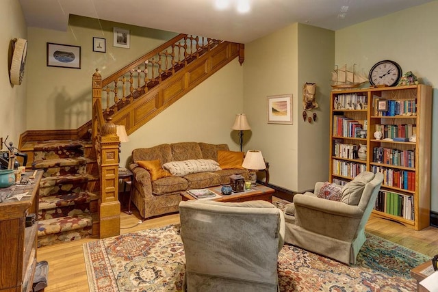 73 Elm St, Otsego, NY 13326 - living room featuring stairway and wood finished floors