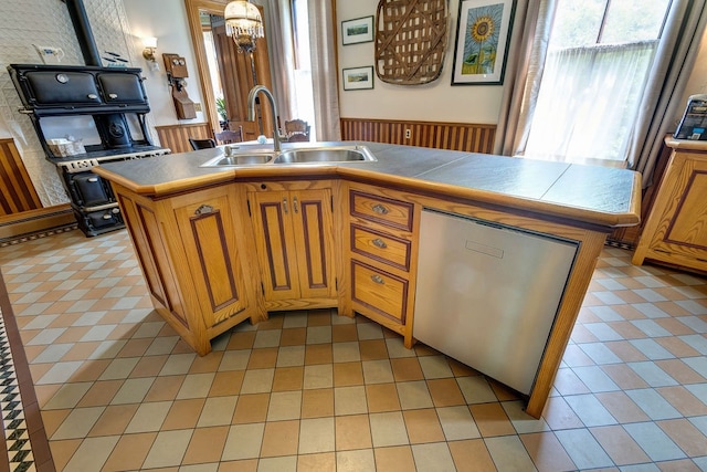 kitchen with tile counters, a center island with sink, sink, and light tile flooring