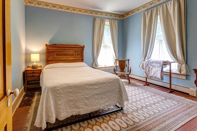 73 Elm St, Otsego, NY 13326 - bedroom featuring wood finished floors, baseboards, and a baseboard radiator