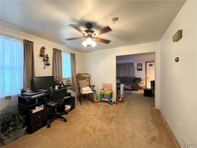 carpeted home office with ceiling fan