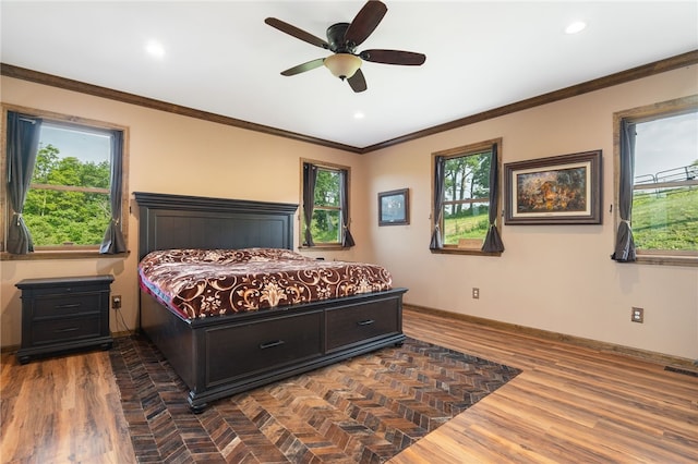 bedroom featuring ceiling fan, crown molding, and dark wood-type flooring