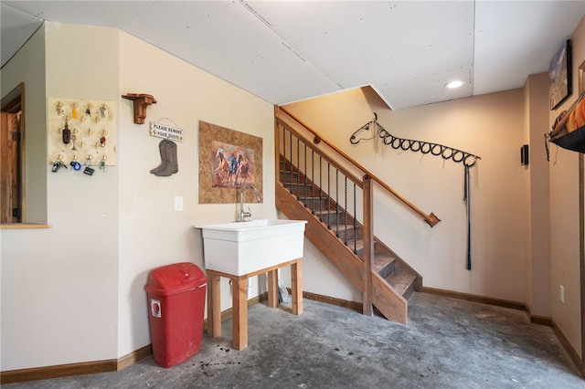 stairway featuring concrete flooring