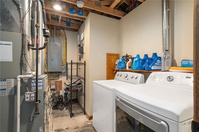 clothes washing area featuring electric panel and washer and clothes dryer