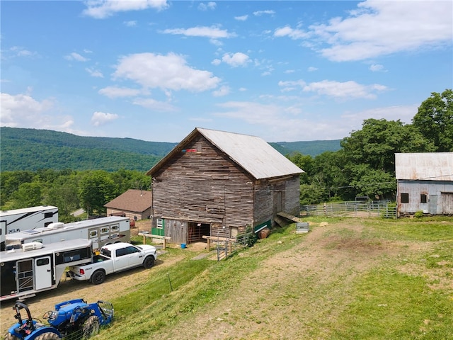 view of home's exterior featuring an outbuilding and a mountain view