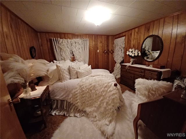 carpeted bedroom with wooden walls