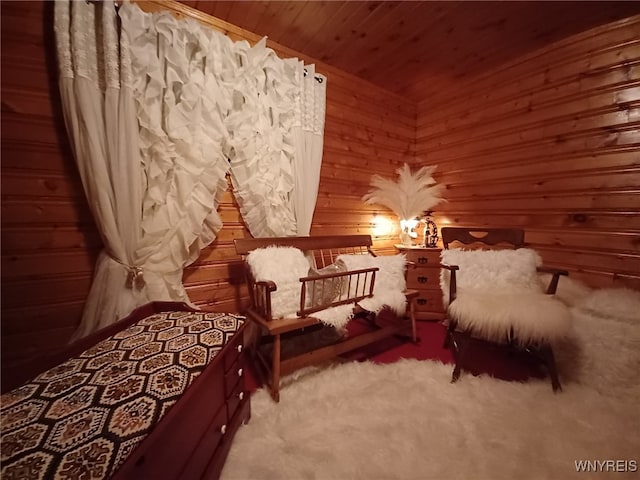 carpeted bedroom with wooden walls and wooden ceiling