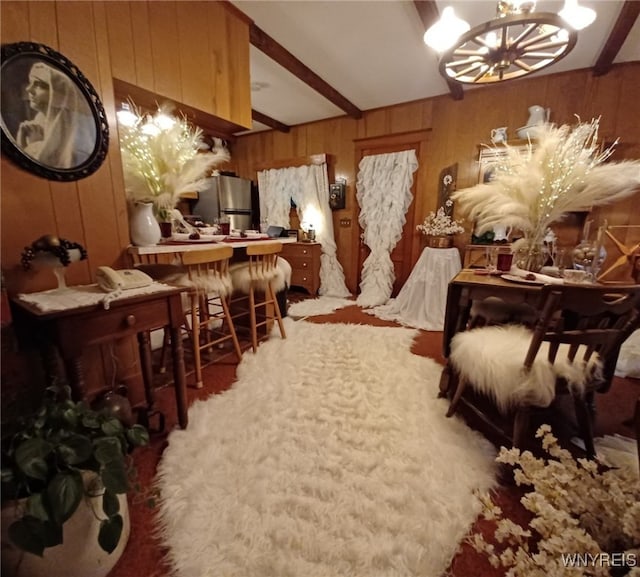 interior space with beamed ceiling, a chandelier, and wood walls