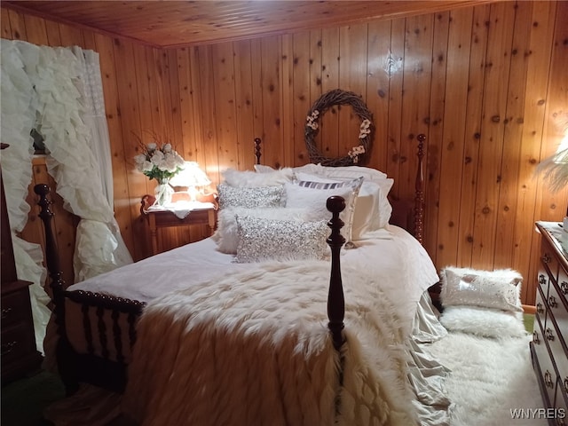 bedroom with wood walls and wooden ceiling