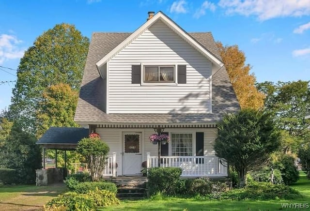 back of house featuring a yard and a porch