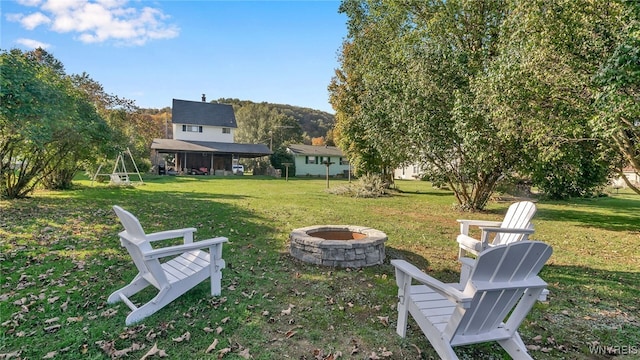 view of yard featuring an outdoor fire pit