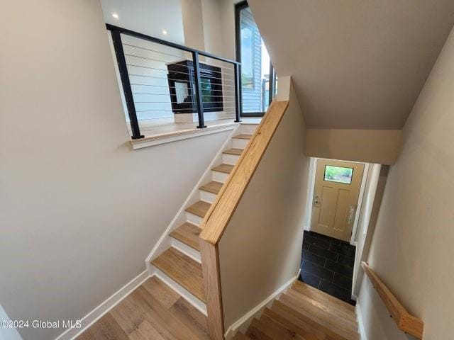 staircase with wood-type flooring