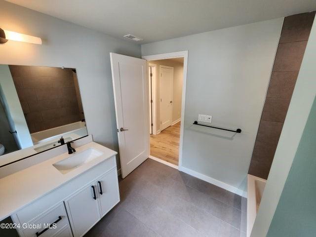 bathroom featuring vanity and wood-type flooring