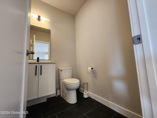 bathroom featuring tile patterned floors, vanity, and toilet