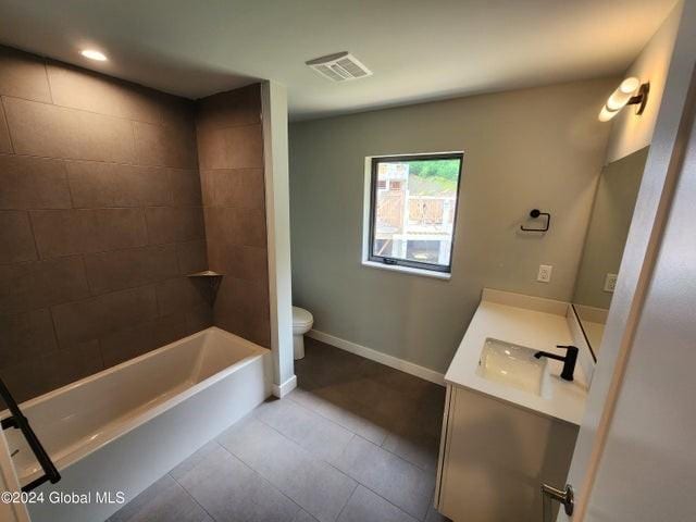 full bathroom with tile patterned flooring, vanity, toilet, and tiled shower / bath combo