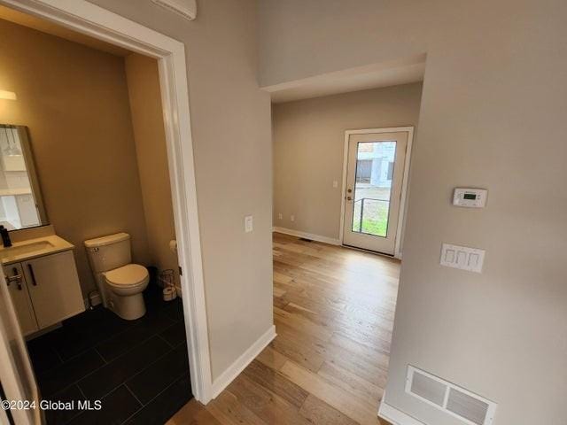 bathroom featuring vanity, toilet, and wood-type flooring