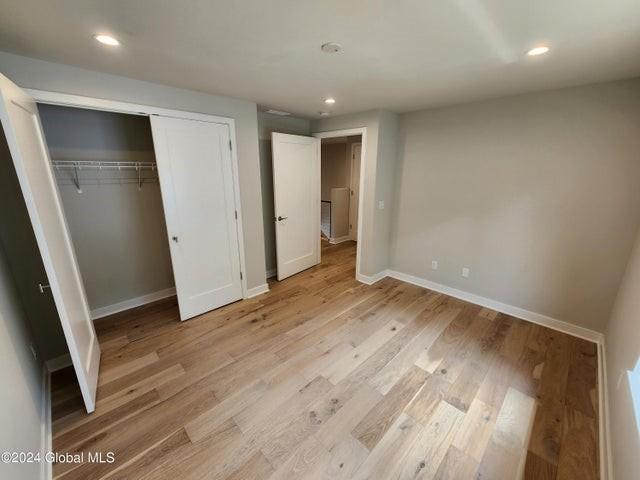 unfurnished bedroom featuring a closet and light hardwood / wood-style flooring