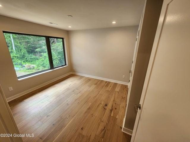 unfurnished room with light wood-type flooring