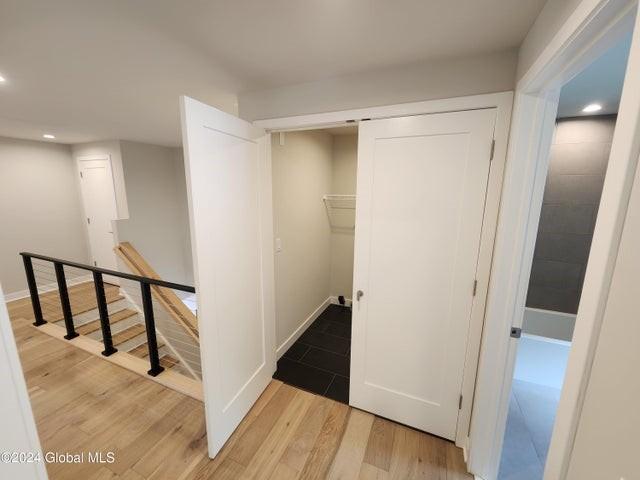 corridor with light hardwood / wood-style floors