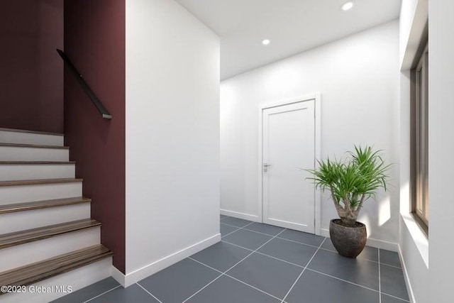 stairway featuring tile patterned flooring