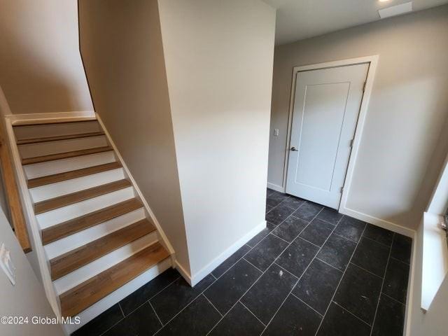 stairway featuring tile patterned floors