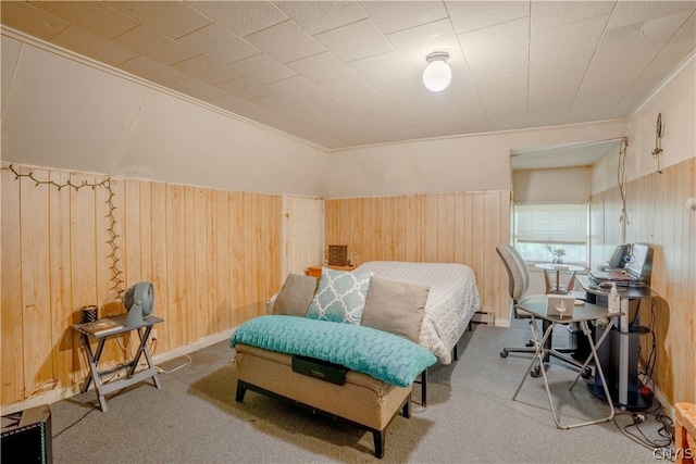 carpeted bedroom featuring ornamental molding and wooden walls