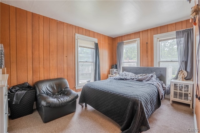 bedroom with wooden walls and carpet flooring