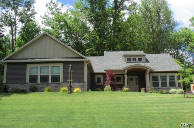 craftsman-style home with a front lawn