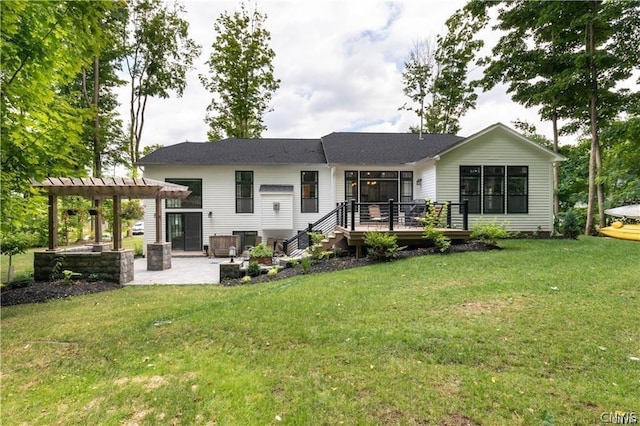 back of house featuring a patio area, a deck, a lawn, and a pergola