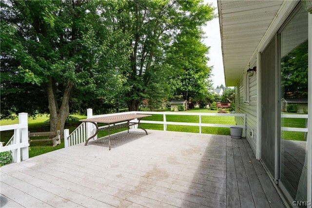 wooden terrace with a yard