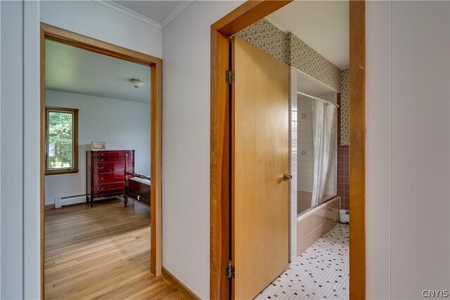 hall featuring crown molding and a baseboard radiator