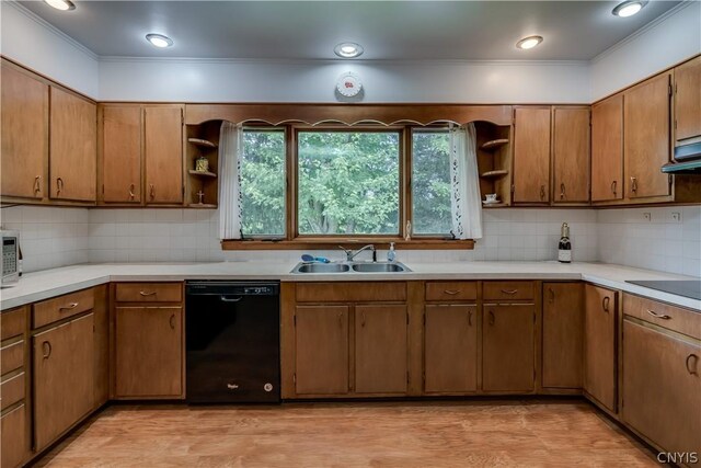 kitchen with black appliances, sink, tasteful backsplash, light hardwood / wood-style floors, and extractor fan