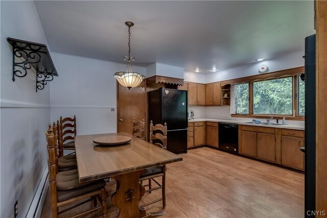 kitchen featuring tasteful backsplash, baseboard heating, light hardwood / wood-style flooring, pendant lighting, and black appliances