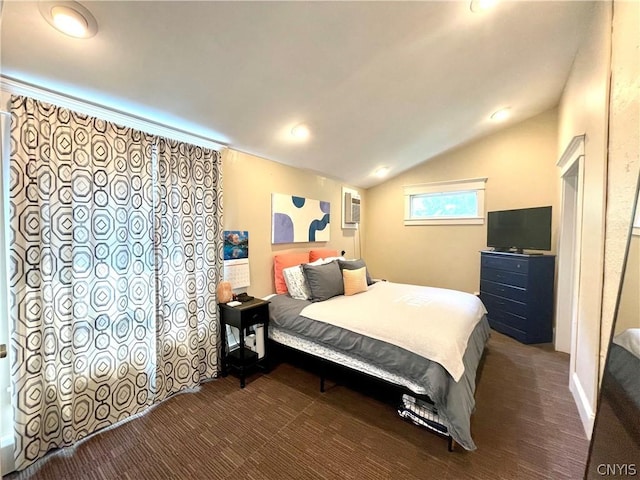 bedroom with dark carpet, an AC wall unit, and lofted ceiling