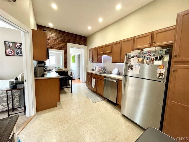 kitchen featuring stainless steel appliances and brick wall